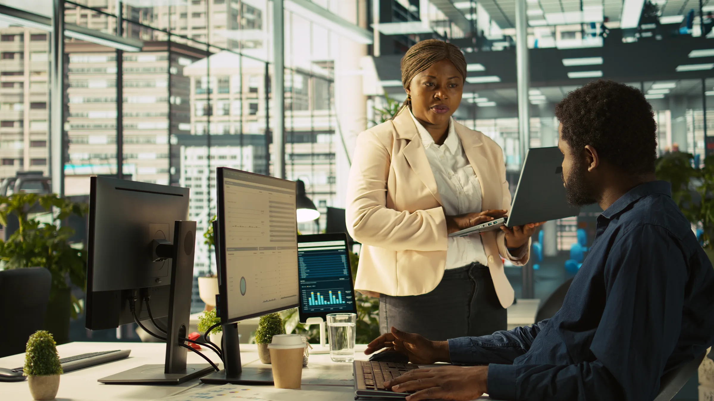 A business adviser discussing digital tools with a client in a bright office
