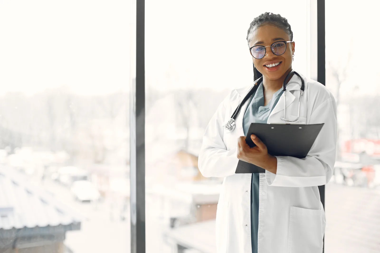 A healthcare professional holding a tablet in a bright workplace