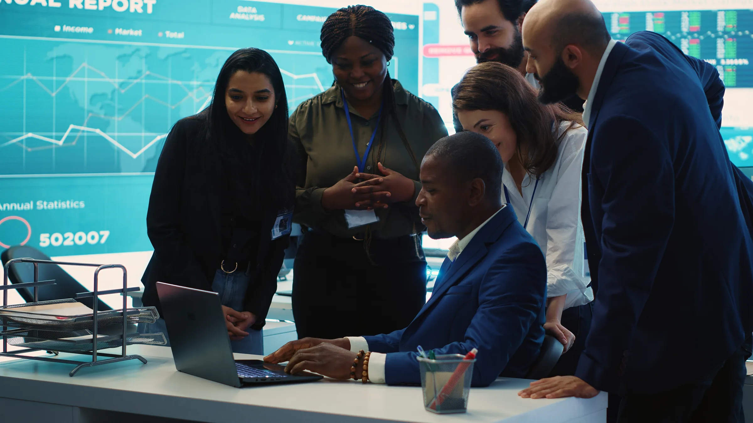 A diverse finance team reviewing a report together around a laptop