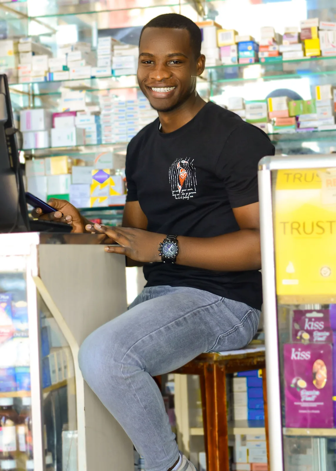A business owner using a digital device inside a retail shop